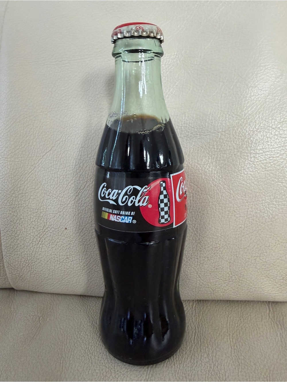 Collectible 8 oz glass bottle of Coca-Cola featuring a NASCAR